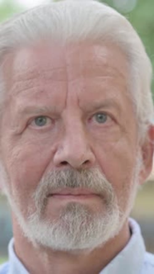 Close up of Serious Senior Old Man Face Outdoor, vertical video