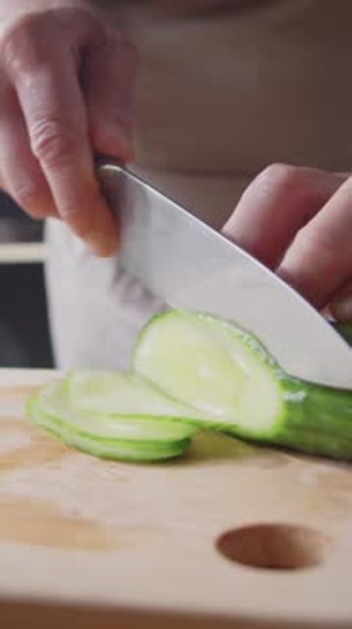 Close-up of Unrecognizable Chef Expertly Slicing Fresh Cucumber