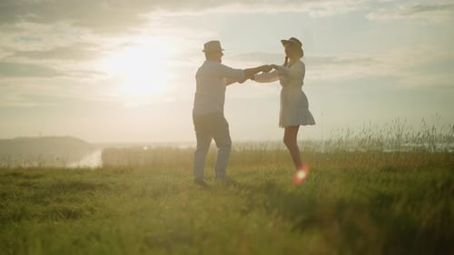 Joyful Dance on Sunlit Grassy Hill By Tranquil Lake at Sunset