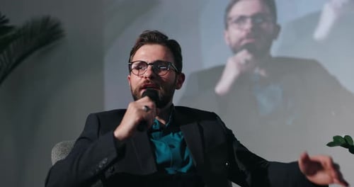 Man Speaking Into Microphone at Corporate Conference