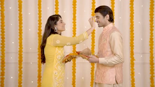 Woman Applying Mark to Man's Forehead