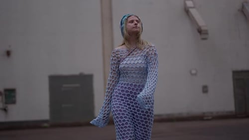 Woman in Fashionable Clothing Walking in Urban Setting