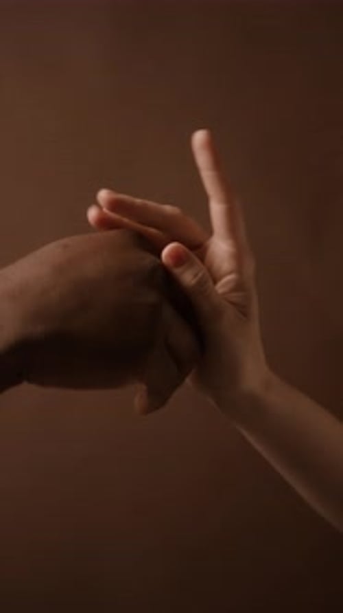 Hands of Multi-ethnic Romantic Couple Touching Each Other with Fingers