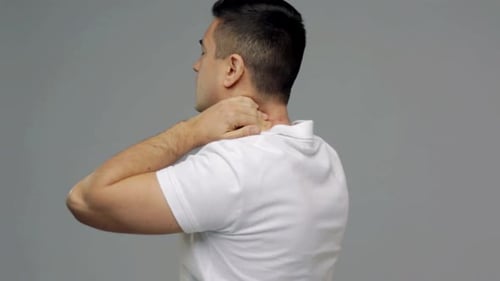 People, Healthcare And Problem Concept - Unhappy Man Suffering From Neck Pain Over Gray Background