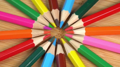 Creative Circle of Colorful Pencils on Wood