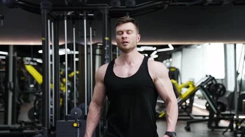 Muscular Man Walking in Gym