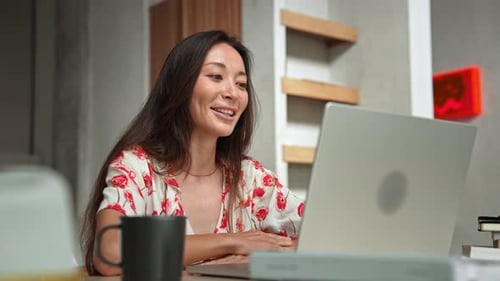 Woman Works Talking at Video Call on Screen of Laptop Computer in Home Office