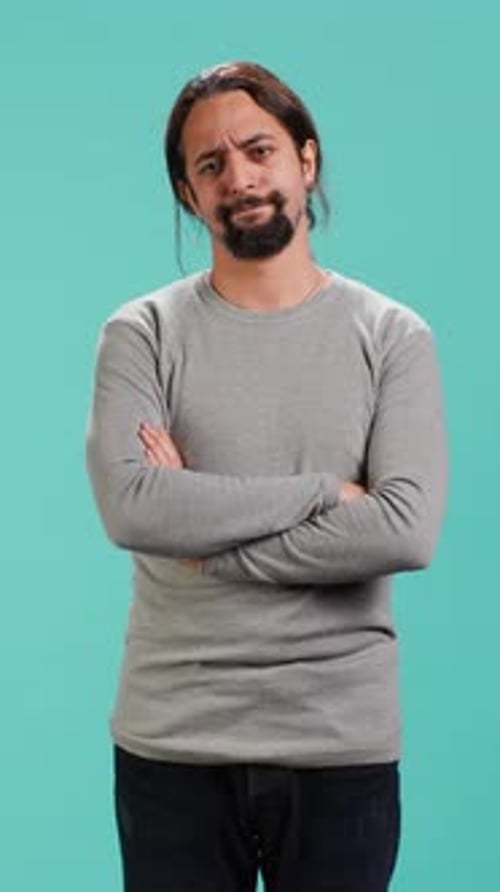 Man With Arms Crossed Smiling In Studio