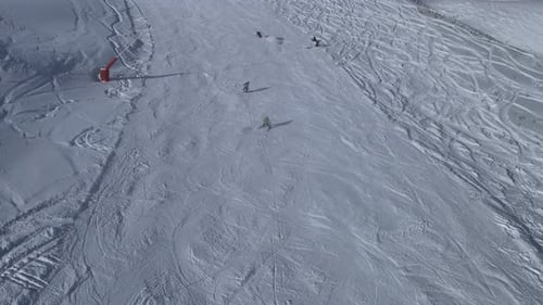 Aerial View of Skiers Descending Snowy Mountain