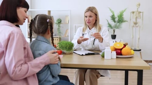 Doctor Discusses Health with Woman and Child