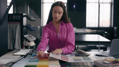 Woman Examines Swatches of Fabric in Office