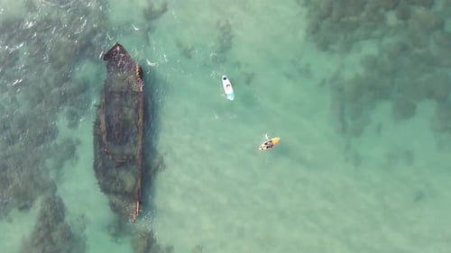 Aerial View Of Tourists Paddle Boarding By Shipwreck In Ocean, Tourists Enjoying Vacation - Arsuf