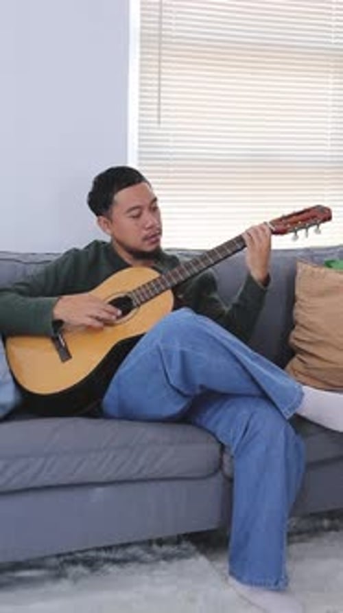 Young Man Play Acoustic Guitar