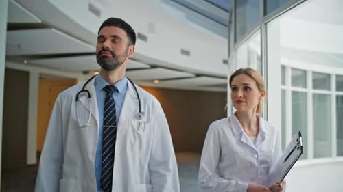 Two Doctors Walking Hospital Greeting Colleague Closeup Medical Team Together