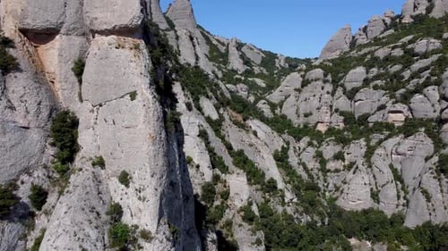 Arial view between the stones at Montserrat in Spain, blue sky with clear blue sky in the distant ba