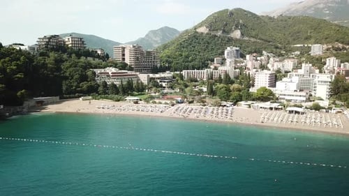 drone approaching beach resort town in Montenegro Adriatic Sea becici budva town travel holiday dest