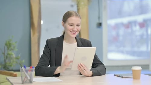 Young Woman on Video Call with Tablet in Office