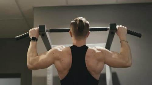 Athlete Doing Pullups in Gym