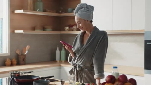 Pretty Woman Typing on Smartphone While Cooking Breakfast Beautiful Caucasian Female Prepare Healthy