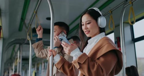 Woman Using Phone on a Moving Train
