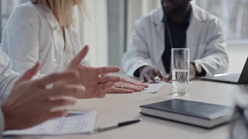 Doctors Sitting at Table for Meetings and Discussing Clinic Affairs