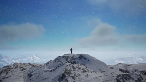 Person Standing On Top Of A Snow Covered Mountain. Cold Snowy Landscape Aerial
