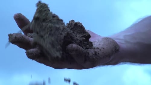 Dirty Hand With Soil And Gravel Stones On Palm Falling. close up