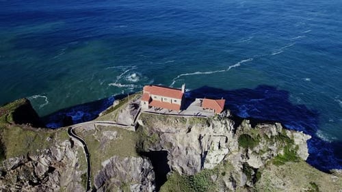 Coastal Building on Rocky Cliffs Aerial View