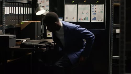 Young Adult Works on Laptop in Office