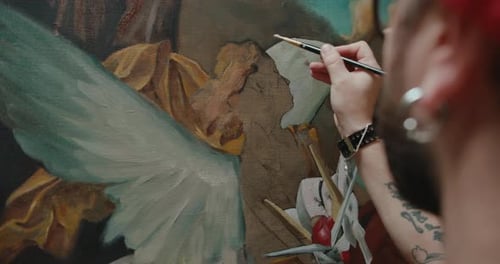 Male Artist Paints a Canvas in His Art Studio