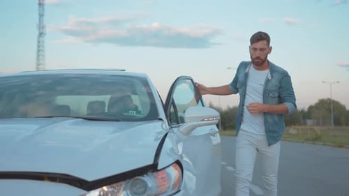 Upset Man Driver Calling Car Services Looking at His Crashed Vehicle After Accident Staying in City