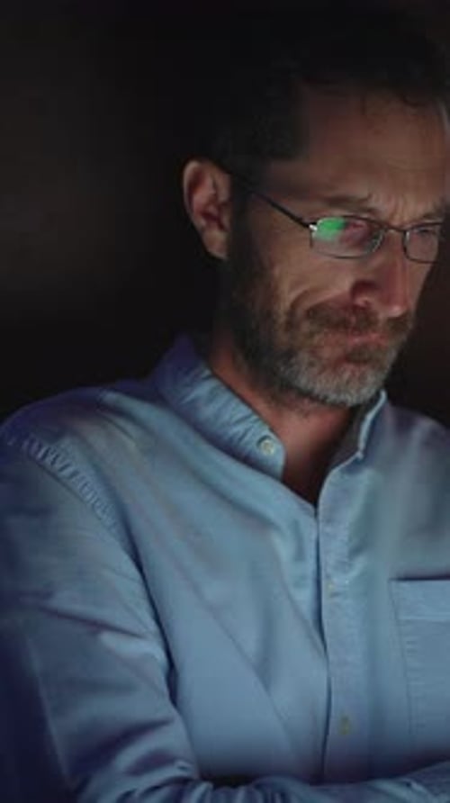 A Contemplative Man is Illuminated By Dim Light Creating a Profound and Introspective Atmosphere