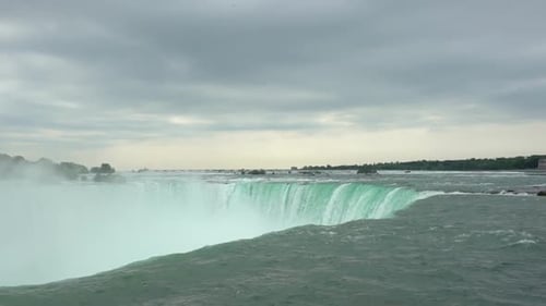 Static slow motion wide shot of the beautiful niagara river and niagara falls in the canadian provin