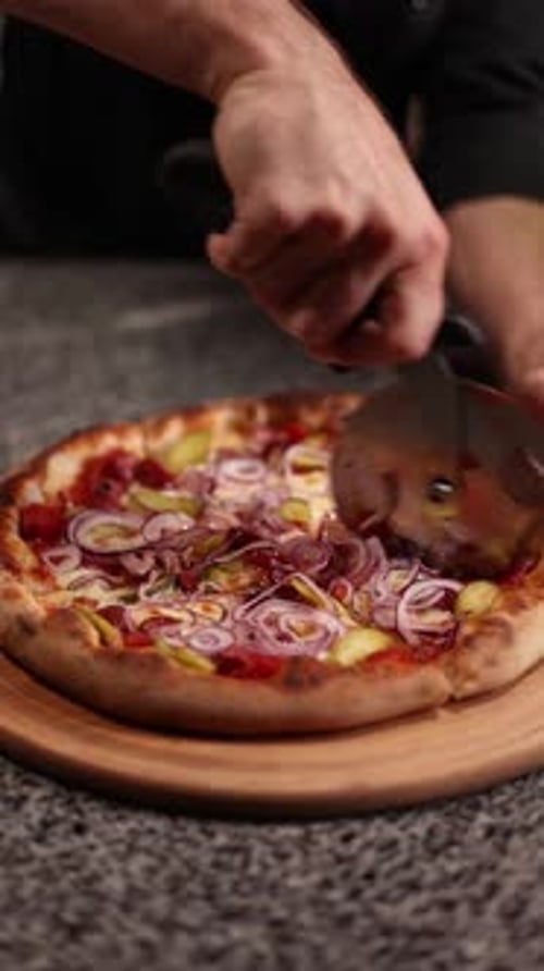 the chef cooks delicious pizza. cut the pizza into portions