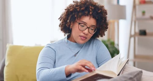 Woman Reads Book on Couch in Cozy Home