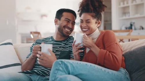 Smiling Couple Enjoying Drinks Together at Home