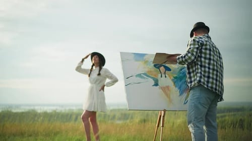 Artist Painting Woman in White Dress Posing in Tranquil Grassy Field