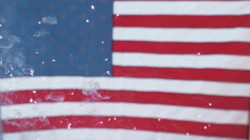 Fireworks Exploding Behind an American Flag Backdrop
