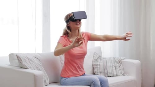 Woman uses Virtual Reality Headset on Sofa