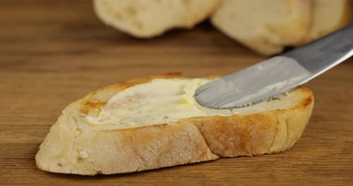 Butter Being Spread on Bread in Close Up