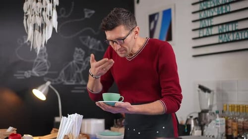 Smiling Barista Expertly Prepares Cup of Coffee