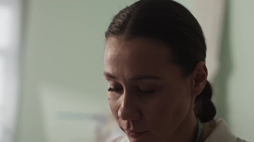 Fashion Designer Sketching at Table in Workshop