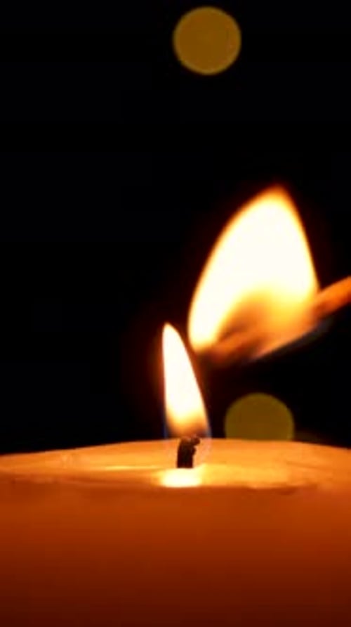 Match Lights Candle Flame Glows in Dark Room