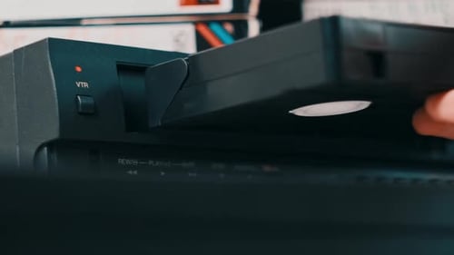 Insert VHS Cassette Into VCR Player