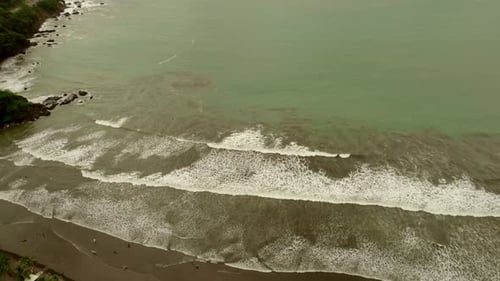 Vast beaches and sea with waves rolling onto shore in Costa Rica