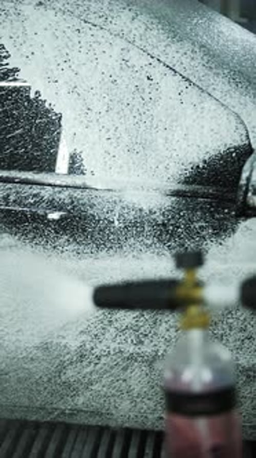 Car Being Detailed with Soap and Sprayed