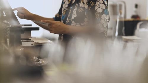 Barista Standing at the Checkout and Taking an Order