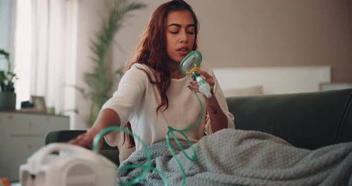 Woman Uses Nebulizer While Sitting on Couch