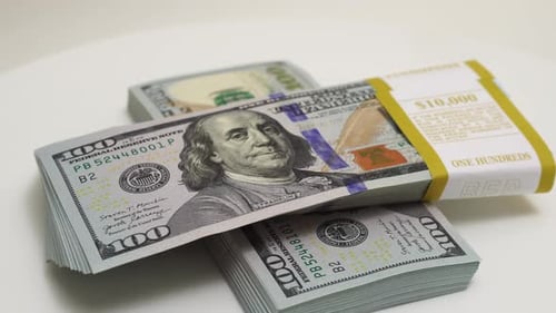 Stack of Bank Bundles with US Dollars on a White Background Closeup Shot of New Freshly Printed