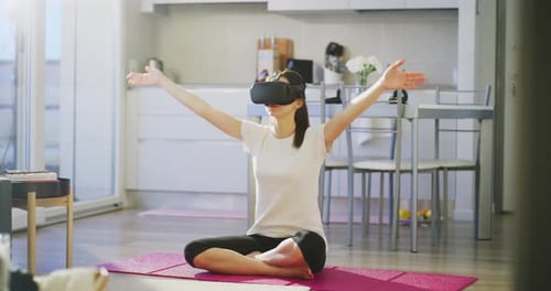 Woman Doing Yoga with VR Headset at Home